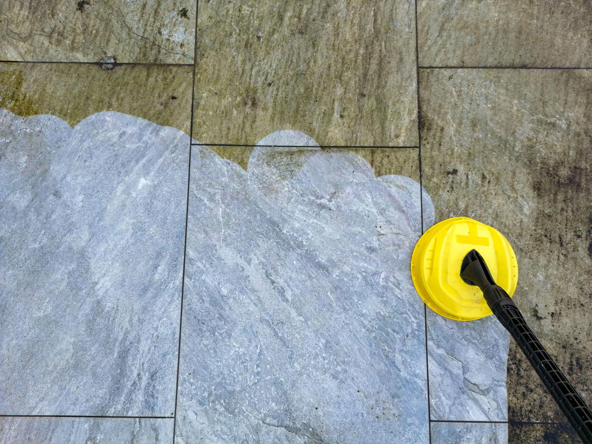 Pressure washer cleaning a garden patio