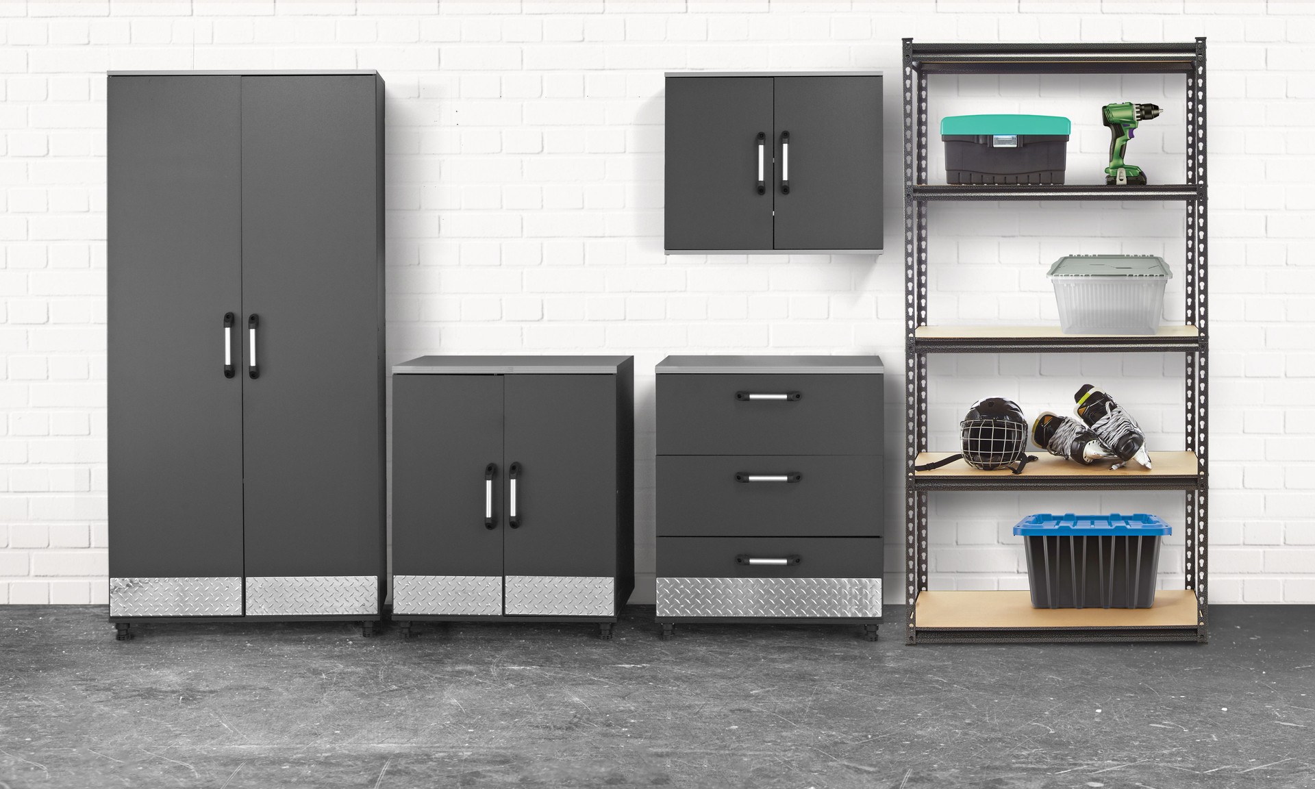 Group of tool chest and cabinets in a garage with brick wall